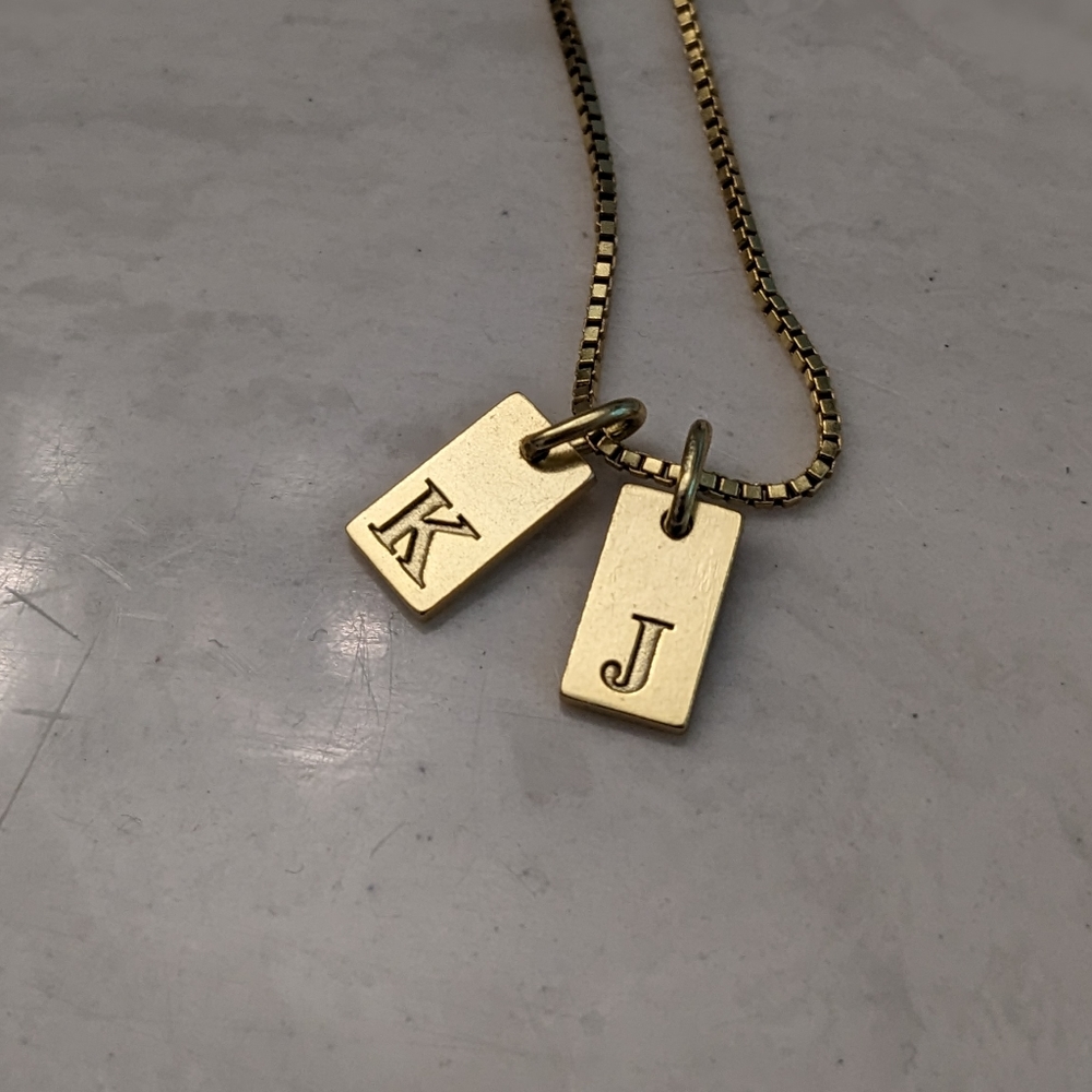 Gold plated initial necklace.